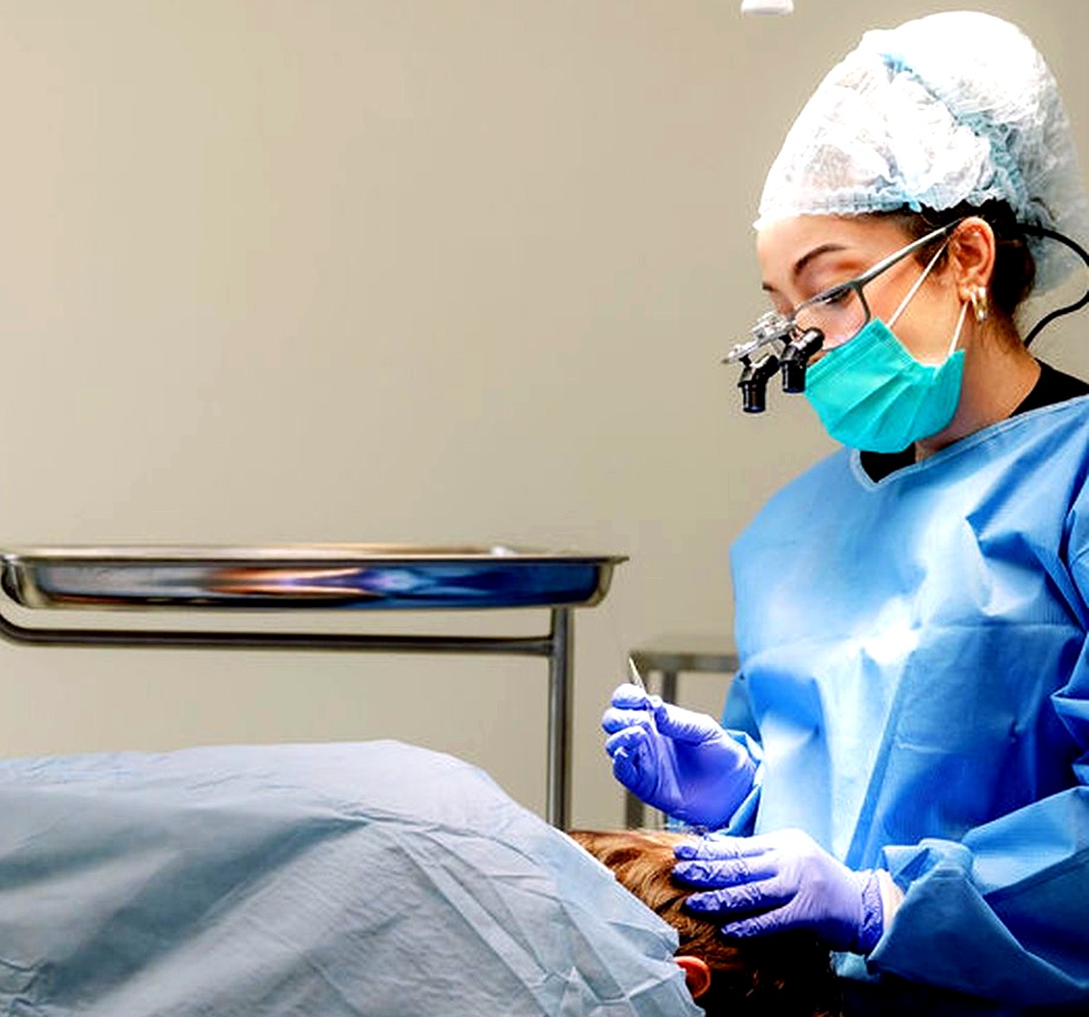 FUE hair transplant being performed under surgical lighting at Gold Coast Hair Transplant, Bundall
